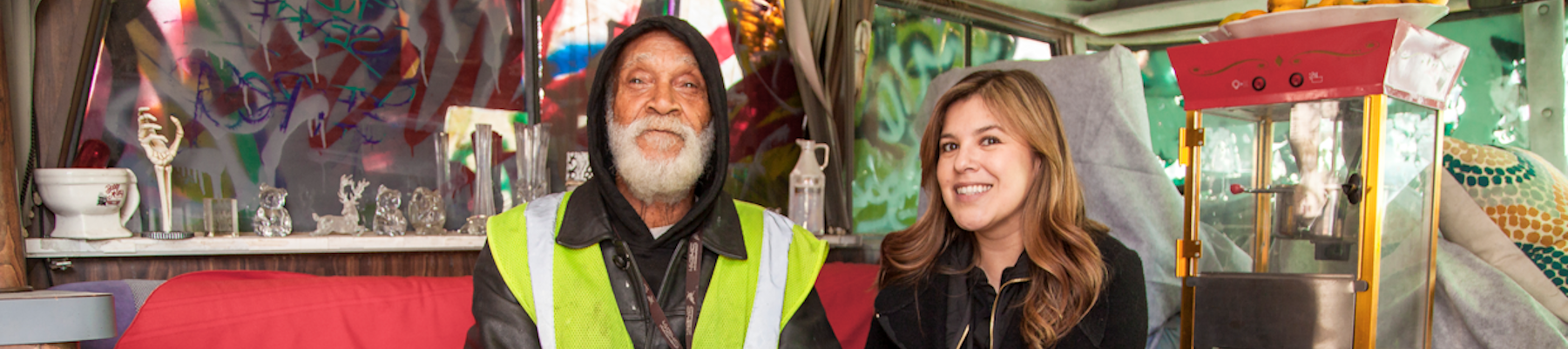 Homeless community outreach Woman sitting in a van with a man wearing a reflective green vest