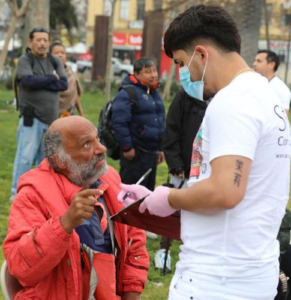 street medicine worker helping patient